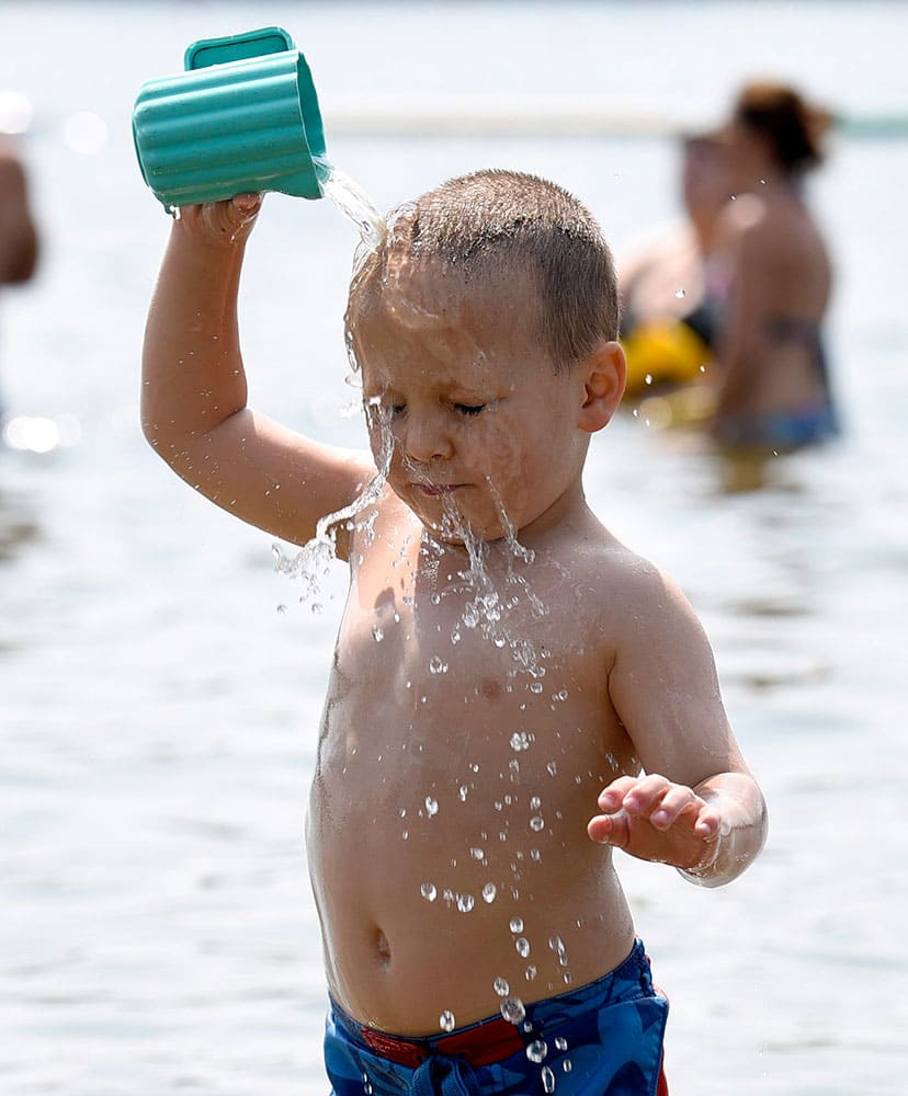 Curran Laing, 3, tries to keep cool at Mooney's Bay Beach in Ottawa.