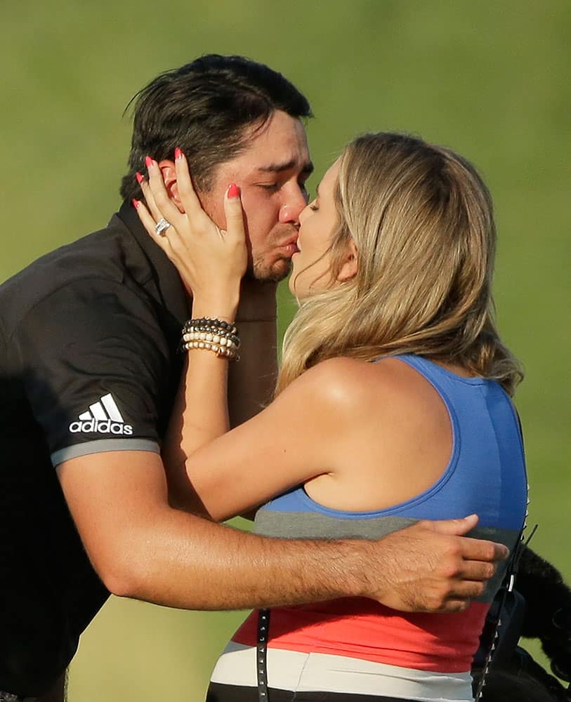 Jason Day, of Australia, kisses his wife Ellie Harvey after winning the PGA Championship golf tournament, at Whistling Straits in Haven, Wis.