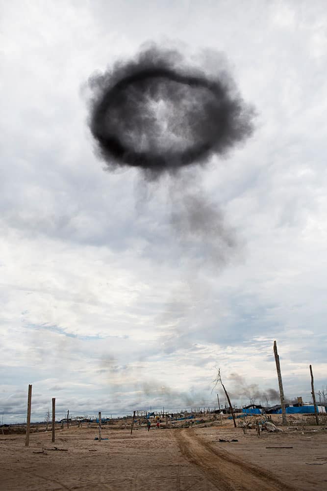 a halo of black smoke created from dynamiting illegal mining equipment hovers over the mining camp during a police operation to eradicate illegal mining in the area known as La Pampa, in Peru's Madre de Dios region. Dozens of wildcat gold miners where arrested in Peru’s latest crackdown on the illegal mining in the Amazon.
