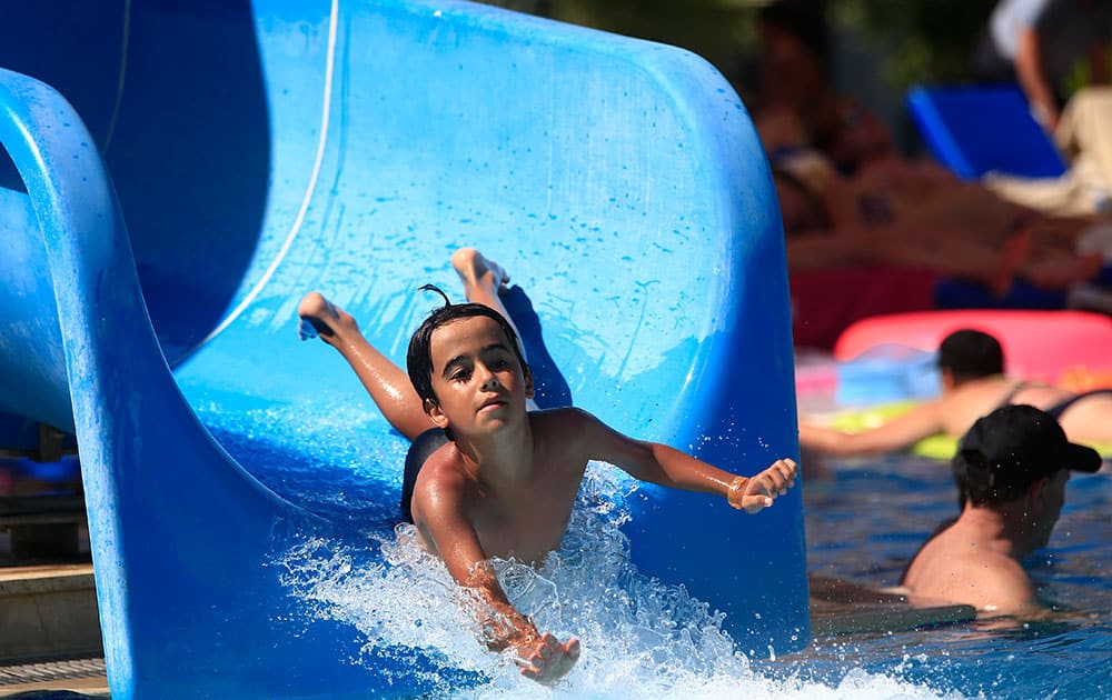 A child enjoys a water slide on a beach near the coastal town of Bodrum, Turkey.