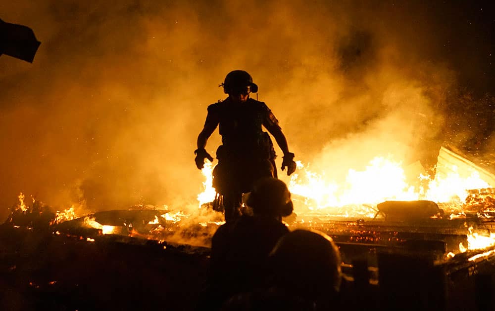 firefighters extinguish fire at a house destroyed by night-long shelling in Donetsk, eastern Ukraine. A night-long artillery exchange in eastern Ukraine bet