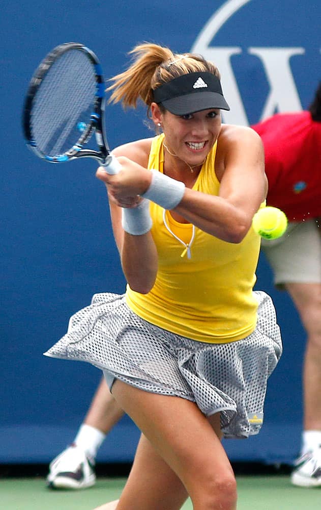 Garbine Muguruza, of Spain, returns the ball to Yaroslava Shedova, of Kazakhstan, during a first round match at the Western & Southern Open tennis tournament.