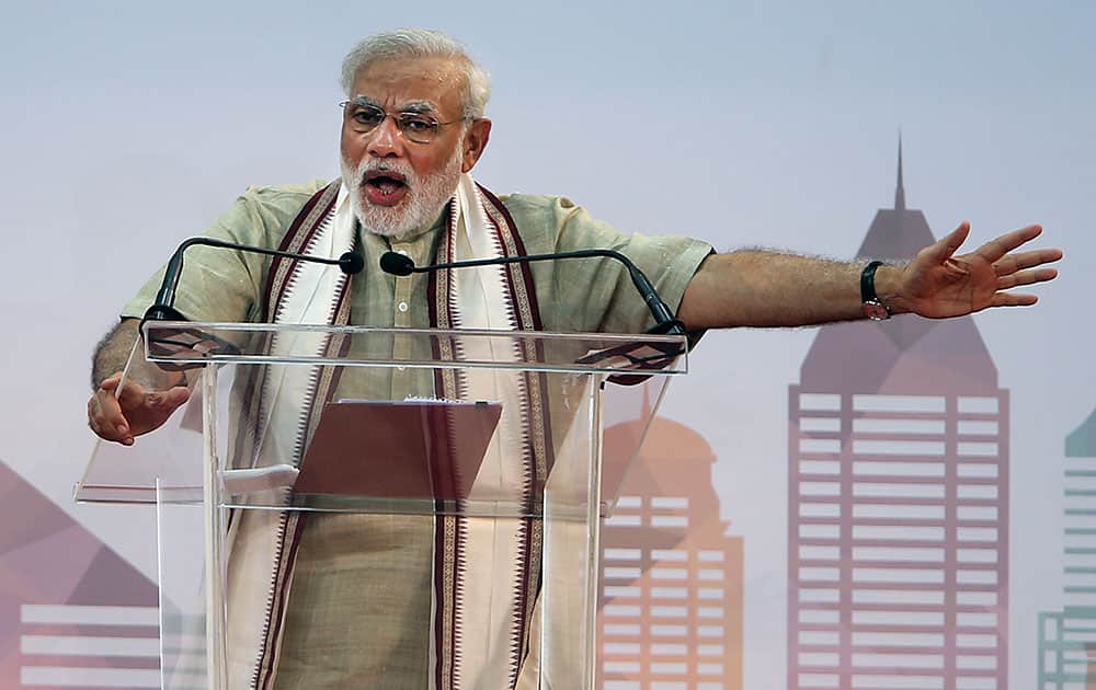 Indian Prime Minister Narendra Modi addresses Indian expatriates at a cricket stadium in Dubai, United Arab Emirates.