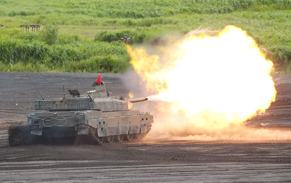 Japan Ground Self-Defense Force Type-10 tank fires its gun at a target during an annual live firing exercise at Higashi Fuji range in Gotemba, southwest of Tokyo.