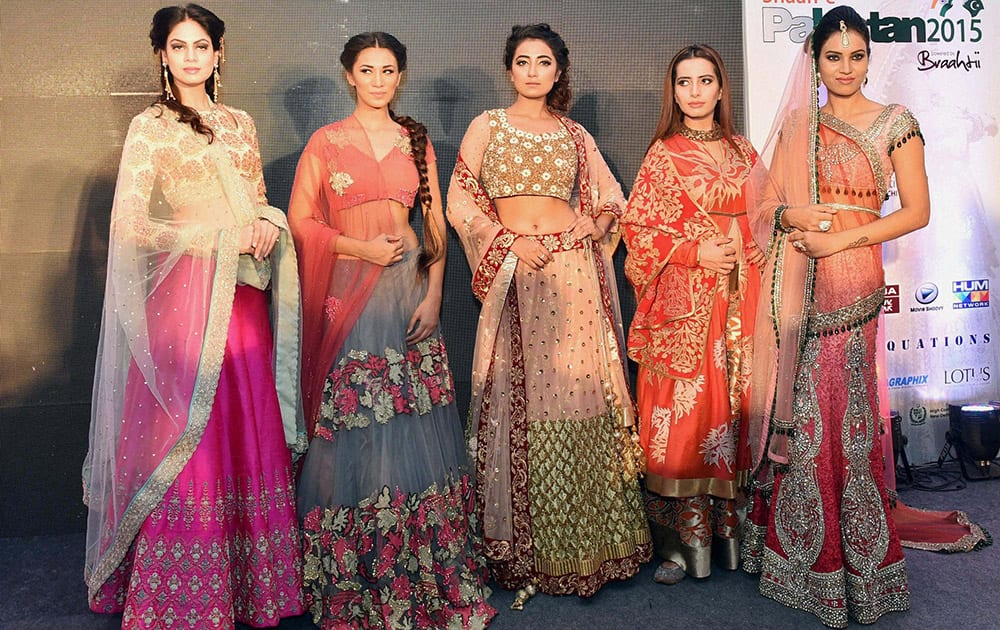 Models pose for a group photo during a Press Conference regarding upcoming Shaan-e Pakistan craft exhibition, which will be held in New Delhi from Sep 10 to 12, in New Delhi.