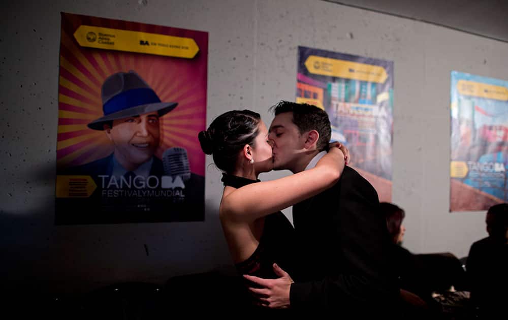 Giselle Tacon and Pablo Nelson share a kiss before competing in the salon category at the World Tango Championship first round in Buenos Aires, Argentina.