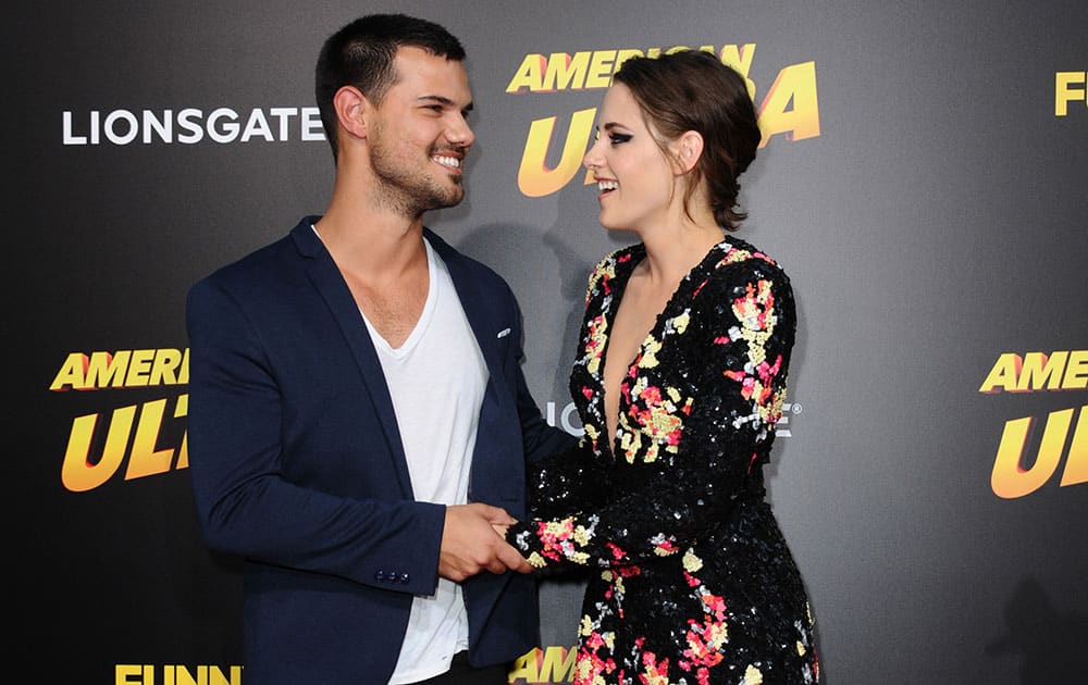 Taylor Lautner, left, and Kristen Stewart arrive at the Los Angeles premiere of 