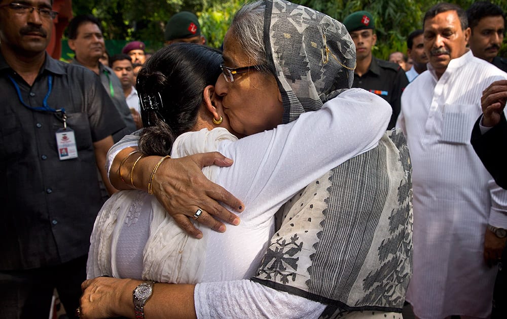 Bangladesh’s Prime Minister Sheikh Hasina, right, embraces Sharmistha Mukherjee, daughter of Indian President Pranab Mukherjee, as she arrives to express her condolences on the demise of Mukherjee's wife Suvra Mukherjee in New Delhi.