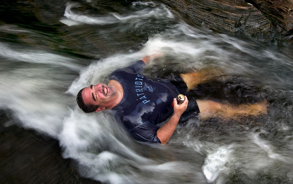 Troy Munford soaks in the waters of Sunday River in Riley Township, Maine.