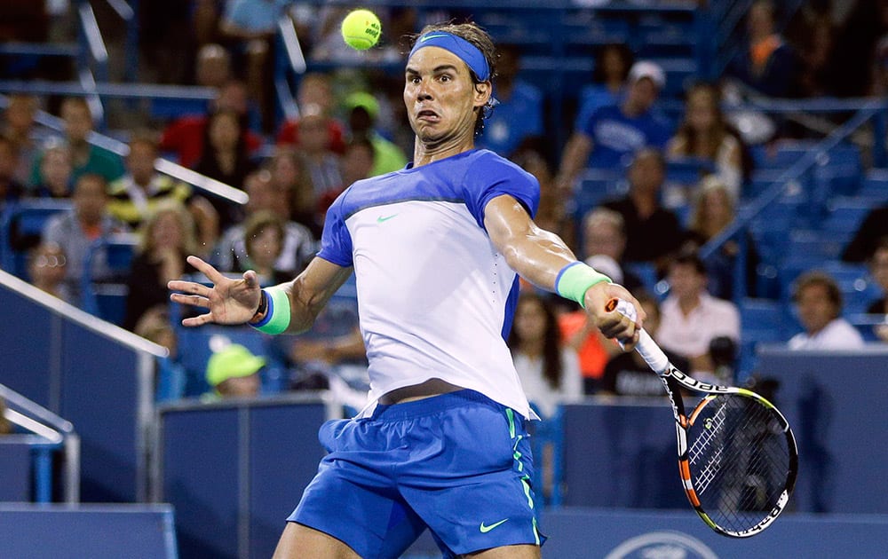 Rafael Nadal, of Spain, returns to Jeremy Chardy, of France, during a match at the Western & Southern Open tennis tournament, in Mason, Ohio.