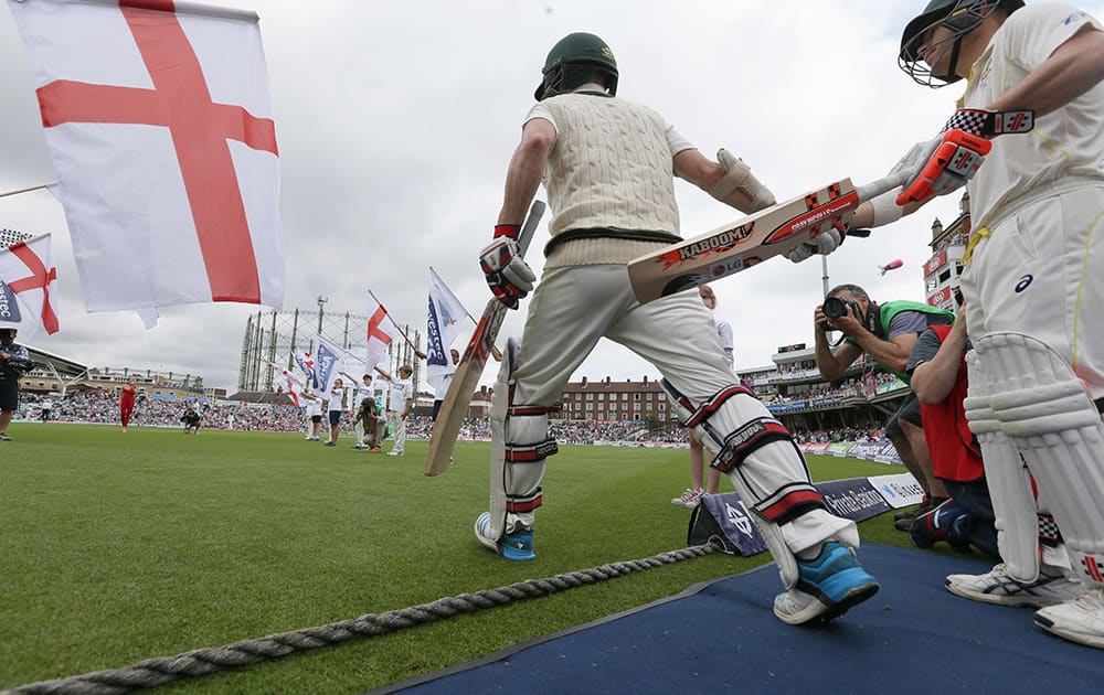 Australia's Chris Rogers and David Warner enter the ground on the first day of the fifth Ashes Test match between England and Australia, at the Oval cricket ground in London.