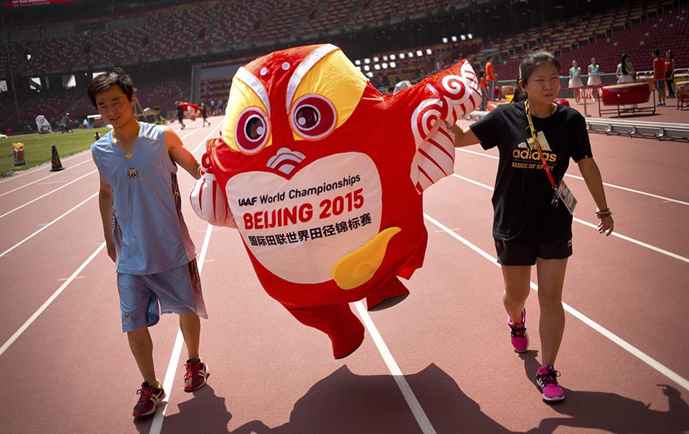 Staffers move a mascot for the World Athletics Championships along the track at the Beijing Olympic Stadium, also known as the Birds Nest, in Beijing.