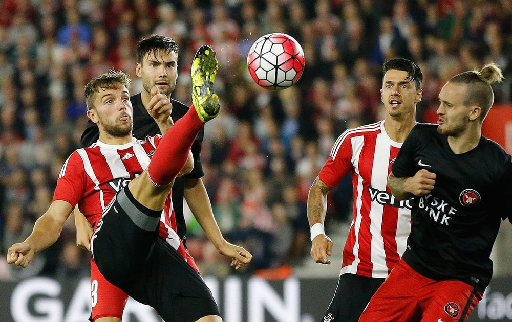 Southampton’s Jay Rodriguez, left, kicks the ball during the Europa League play-off first leg soccer match between Southampton and Midtjylland in Southampton, England.