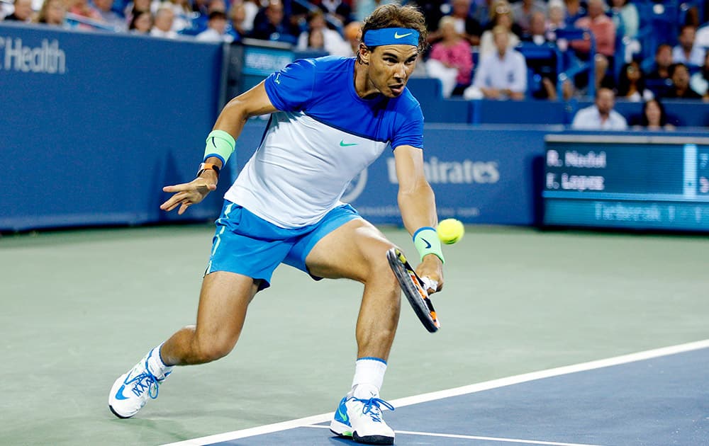 Rafael Nadal, of Spain, returns to Feliciano Lopez, of Spain, during a match at the Western & Southern Open tennis tournament, in Mason, Ohio. Lopez won 5-7, 6-4, 7-6 (3).