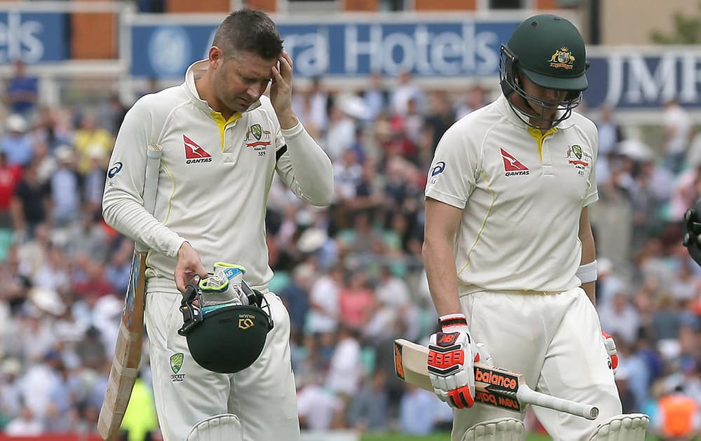 Australia's Michael Clarke, left, and Steven Smith leave the field as they break for tea on the first day of the fifth Ashes Test match between England and Australia, at the Oval cricket ground in London.