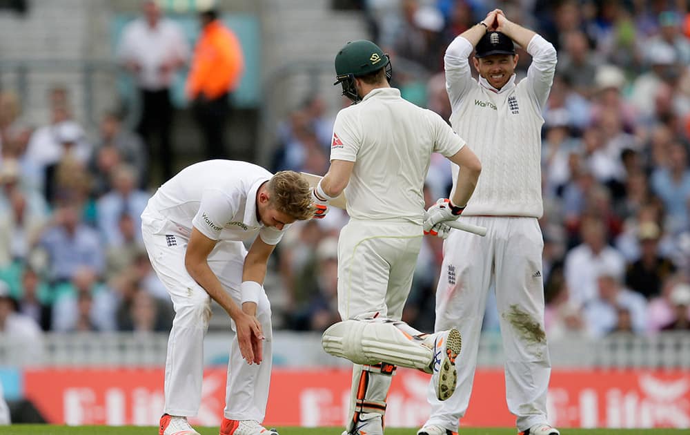 England's Stuart Broad, left, reacts after bowling to Australia's Steven Smith on the first day of the fifth Ashes Test match between England and Australia, at the Oval cricket ground in London.