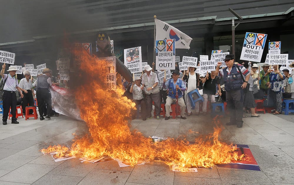 South Korean protesters burn an effigy of North Korean leader Kim Jong Un and a North Korean flag during an anti-North Korean rally in Seoul, South Korea.