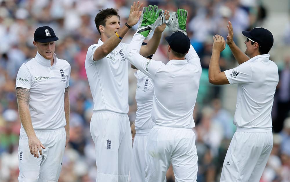 England’s Steven Finn celebrates taking the wicket of Australia’s Mitchell Marsh on the second day of the fifth Ashes Test match between England and Australia, at the Oval cricket ground in London.