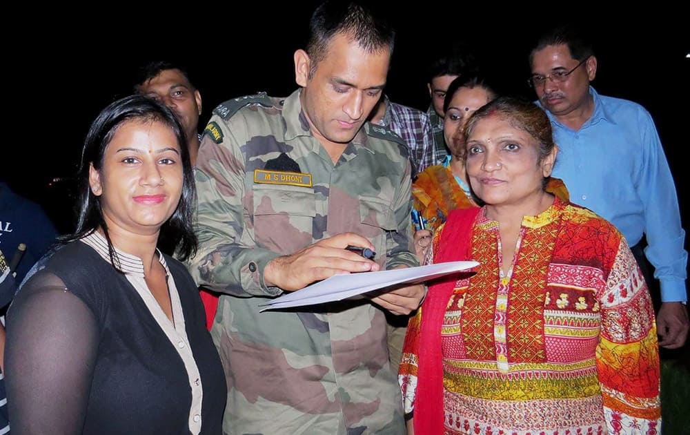 MS Dhoni who is a Lietenant Colonel in the Territorial Army giving autographs to fans during a dinner organised in his honour at Air Force Station Agra.