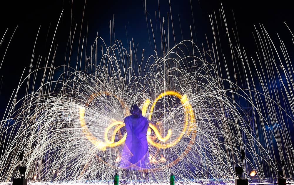 Long exposure photo shows fire spinners whirling fire as they take part in a two-day Fire Festival 'Miff-2015' in outskirts of Minsk, Belarus.
