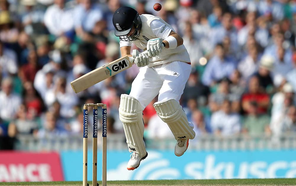 England’s Joe Root tries to play a shot off the bowling of Australia’s Mitchell Johnson on the second day of the fifth Ashes Test match between England and Australia, at the Oval cricket ground in London.