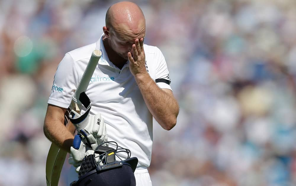 England’s Adam Lyth wipes his face as he walks off the pitch after being given out caught behind by Australia’s Michael Clarke off the bowling of Australia’s Peter Siddle on the third day of the fifth Ashes cricket test between England and Australia at the Oval cricket ground in London.