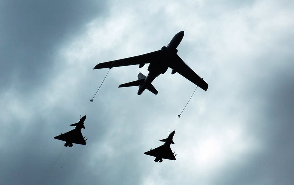 A Chinese military refueling tanker aircraft flies with fighter jets during rehearsals ahead of the Sept. 3 military parade to commemorate the end of World War II in Beijing.