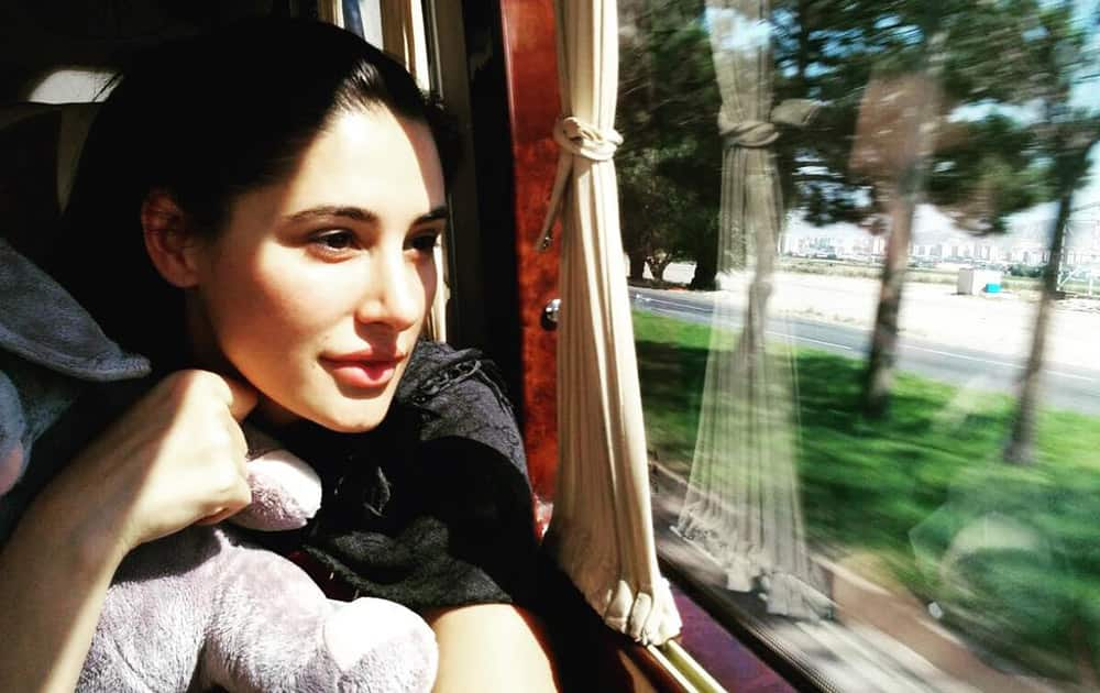 nargis fakhri :- On a Bus to my destination. There's something extremely exciting about the journey to the destination. Anticipation, excitement of what's to come! Stay tuned and follow us around! #globetrotter #NargisWasHere #travel #waitforit #locationmystery -instagram
