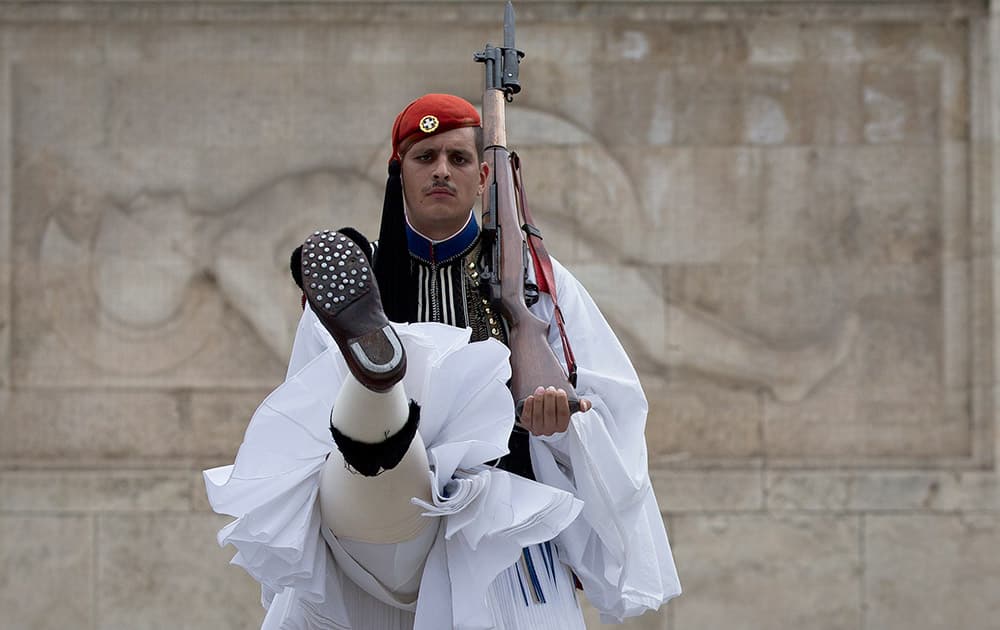 A Greek presidential guard performs during the changing of the guards ceremony at the tomb of the unknown soldier in central Athens.