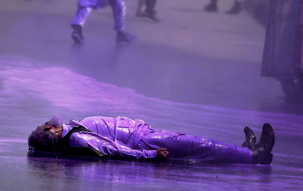 An injured elderly Hurriyat activist lies on ground after being hit by coloured water cannon used by police to disperse supporters of Hurriyat chairman Syed Ali Shah Geelani during their protest rally against Geelanis house arrest, outside his residence at Hydepora in Srinagar.