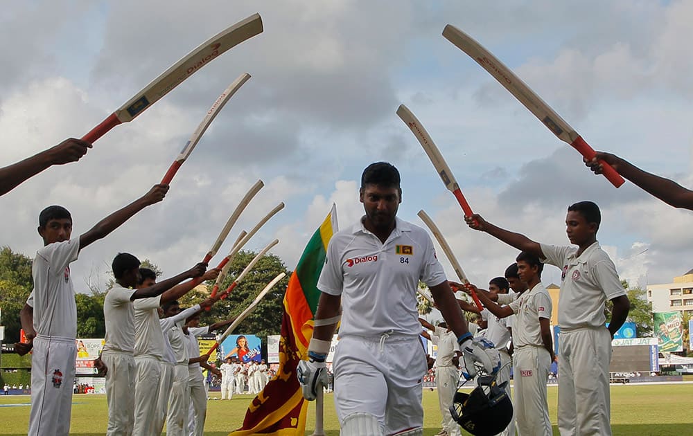 Sri Lanka's Kumar Sangakkara leaves the field after playing his final test innings during the fourth day's play of the second test cricket match between Sri Lanka and India in Colombo, Sri Lanka.