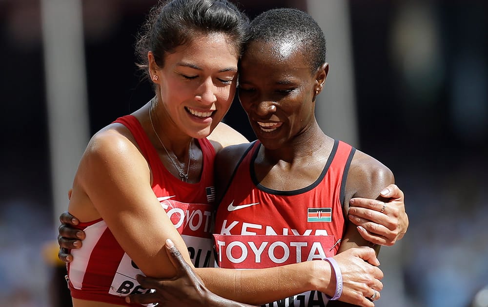 United States' Stephanie Garcia, left, and Kenya's Virginia Nyambura Nganga hug following heat one of the women’s 3000m steeplechase at thebWorld Athletics Championships at the Bird's Nest stadium in Beijing.