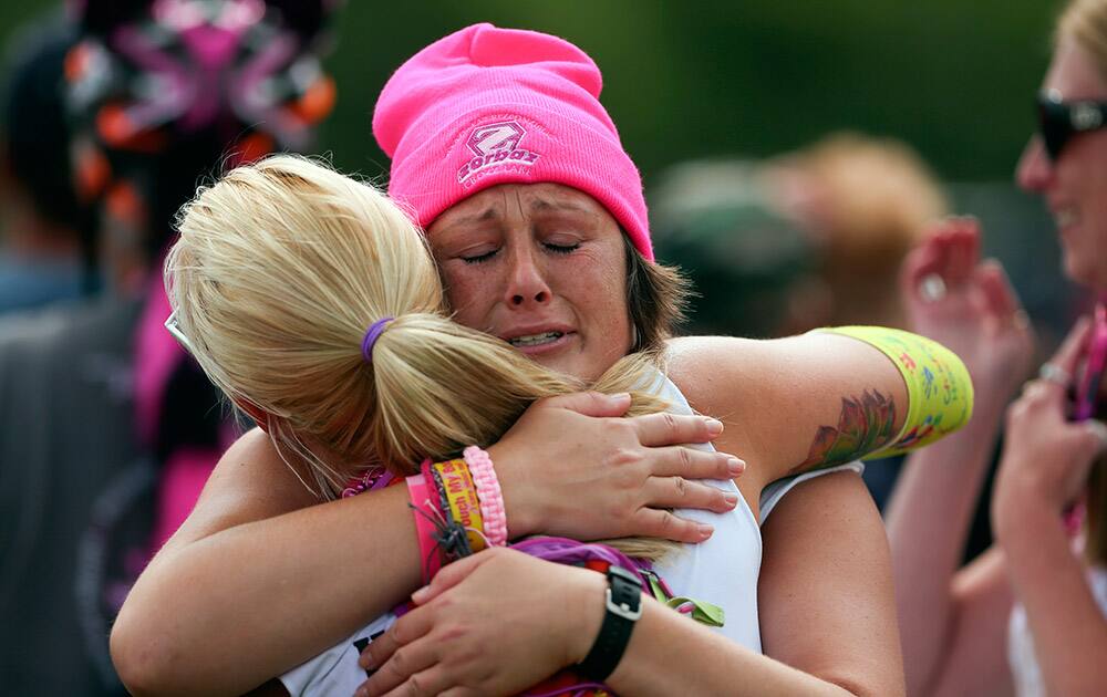 Nicole Logan of Hancock, Minn., was hugged by a friend after she finished the walk in St. Paul, Minn.