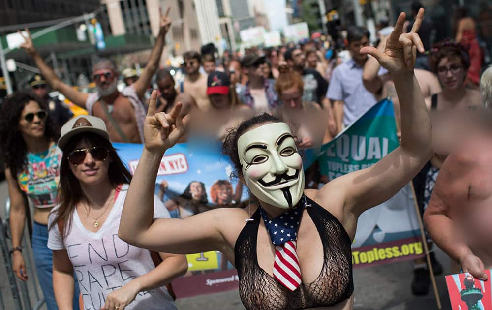 Topless activist Phoenix Feeley marches in the protest march called the GoTopless Day Parade in New York.