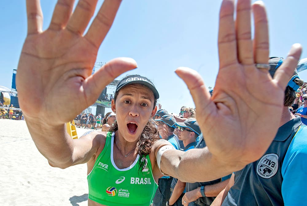 Talita Da Rocha Antunes high-fives the photographers after winning gold at the FIVB World Series of Beach Volleyball event in Long Beach, Calif.