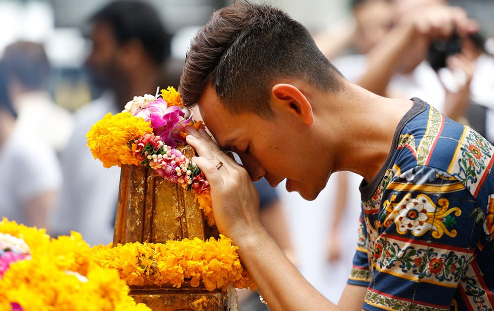 A man prays at the Erawan Shrine at Rajprasong intersection, the scene of last week's bombing, in Bangkok, Thailand.