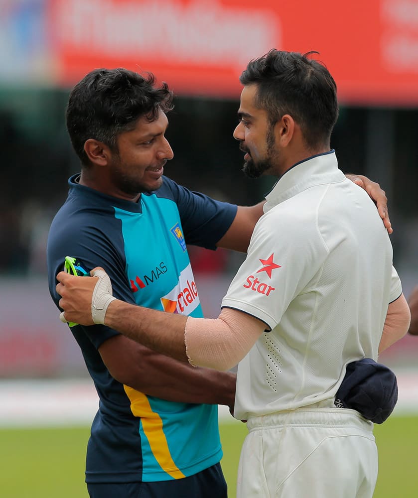 Indian cricket captain Virat Kohli, right, greets Sri Lankan cricketer Kumar Sangakkara after the second test cricket match between Sri Lanka and India in Colombo, Sri Lanka.