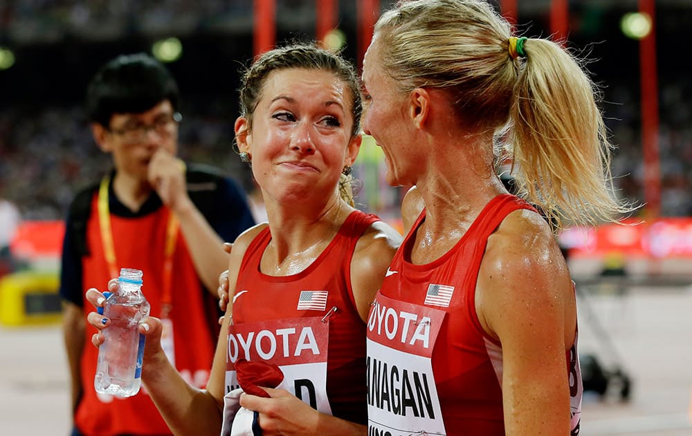 Emily Infeld, left, smiles at compatriot Shalane Flanagan after winning the bronze medal in the women's 10,000m final at the World Athletics Championships at the Bird's Nest stadium in Beijing.