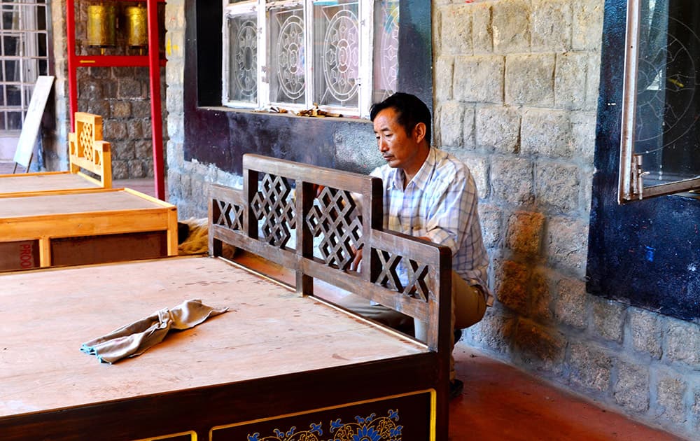 An artisan finishing off a bed at the Norbulingka Institute.