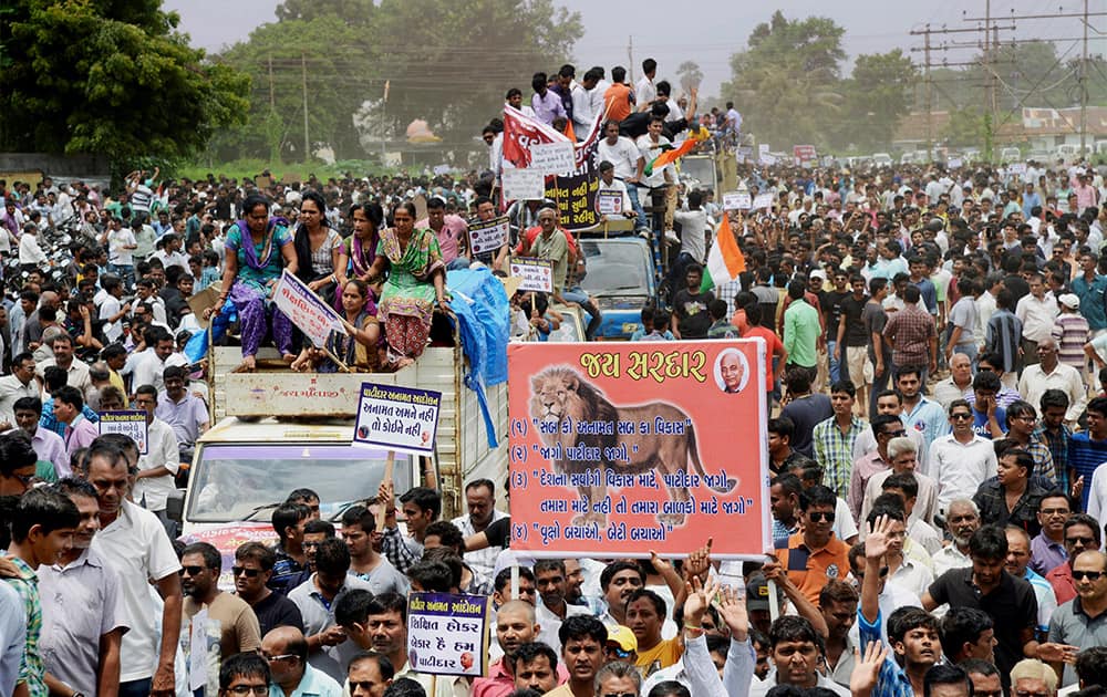 People from Patidar or Patel community hold placards and shout slogans during a protest rally demanding reservation for their community in Vadodra.