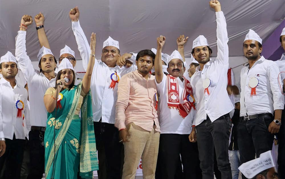 Leaders from Patel or Patidar community raise their hands attending a reservation rally led by Bardik Patel (center) at Bapunagar in Ahmedabad.