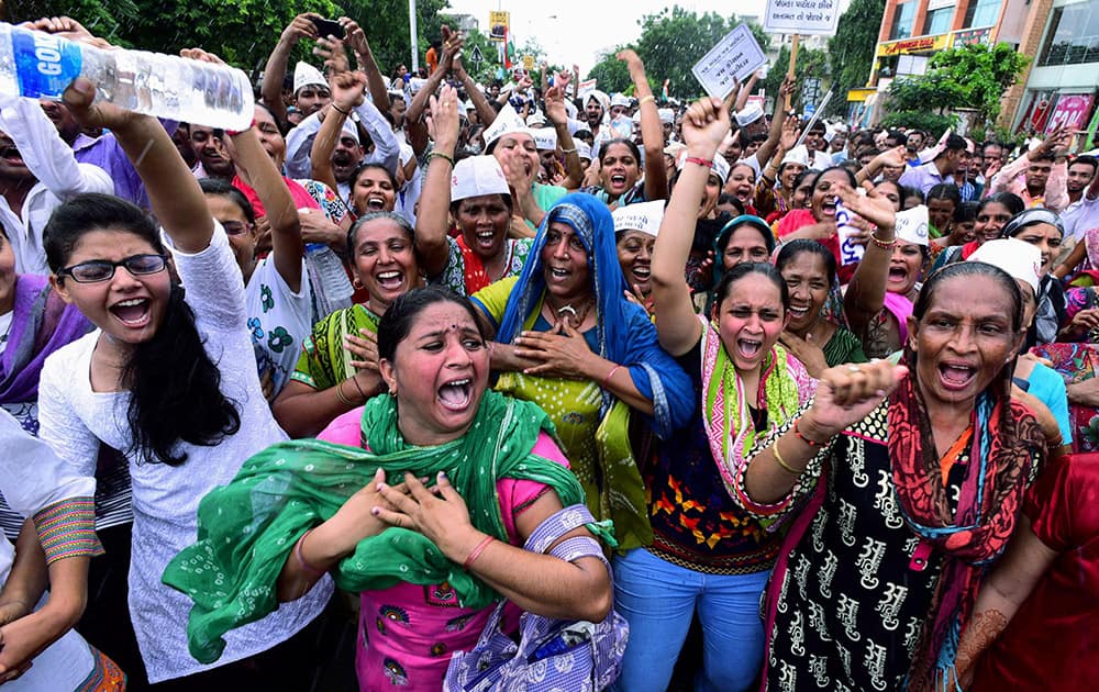 Female members of Patel (Patidar) community holding placards, raise slogans during the Kranti rally (revolution march) to press their demands for reservation, at GMDC Ground in Ahmedabad.