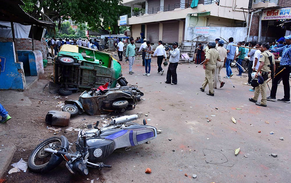 Police charge Patel community members after their agitation for reservation turned violent in Ahmedabad.