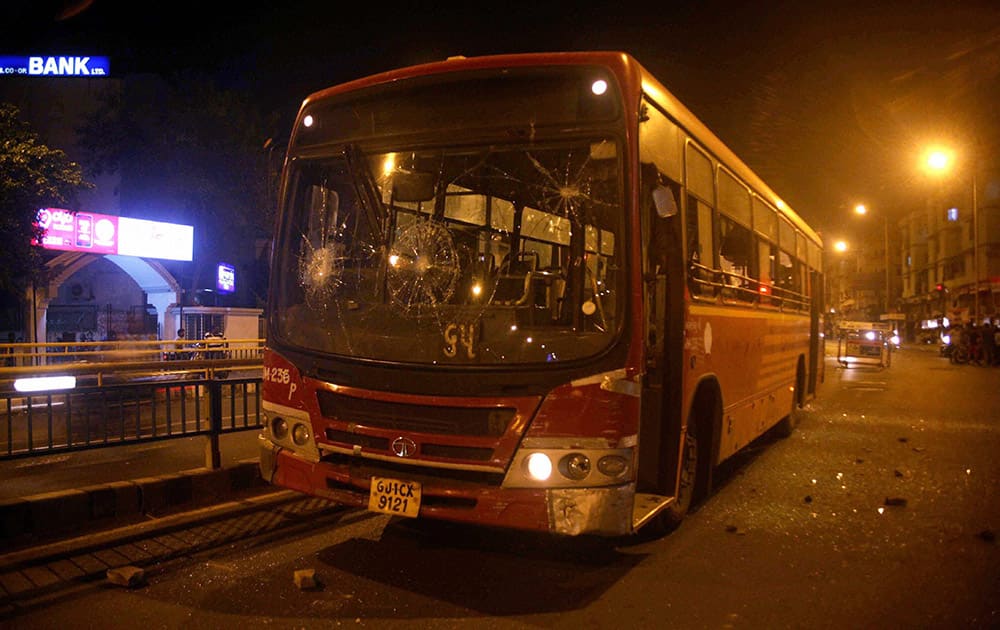 A bus damaged by people after the arrest of Hardik Patel, convener of Patidar Anamat Andolan Samiti, in Ahmedabad.