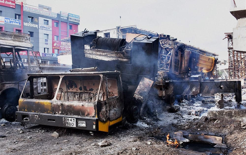 Patel community supporters set ablaze earth movers in Surat on Wednesday. Patel community is agitating for OBC status.