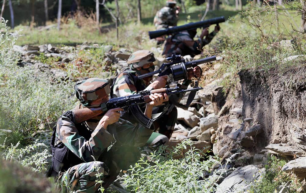 Army personnel take positions during an encounter with the militants near the Line of Control in Uri.
