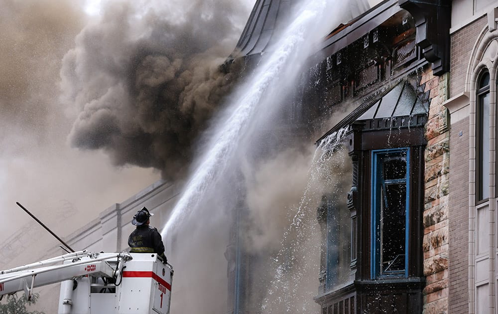 Chicago firefighters battle a fire in a building that houses the offices of Chicago's famed Second City theater company in Chicago.