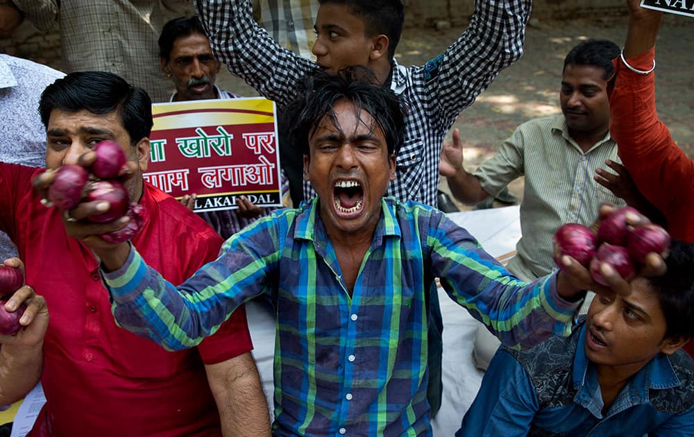 Members of National Akali Dal party shout slogans as they protest against the government for its failure to contain the prices of onion and other essential commodities in New Delhi.