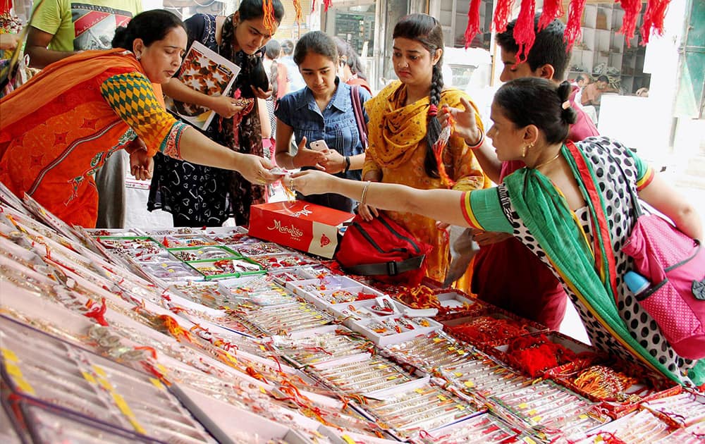 Women and grils buy Rakhi for Raksha Bandhan festival in Jammu.