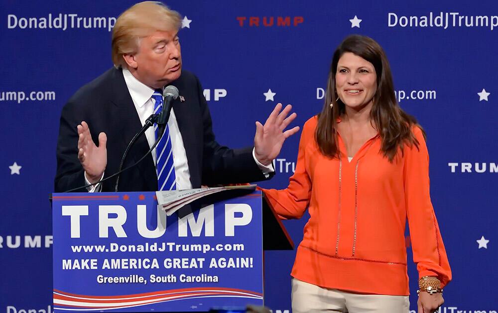 Republican presidential candidate Donald Trump has a supporter, Mary Margaret Bannister, check to see if his hair is real during his speech to supporters during a rally at the TD Convention Center in Greenville, S.C. 